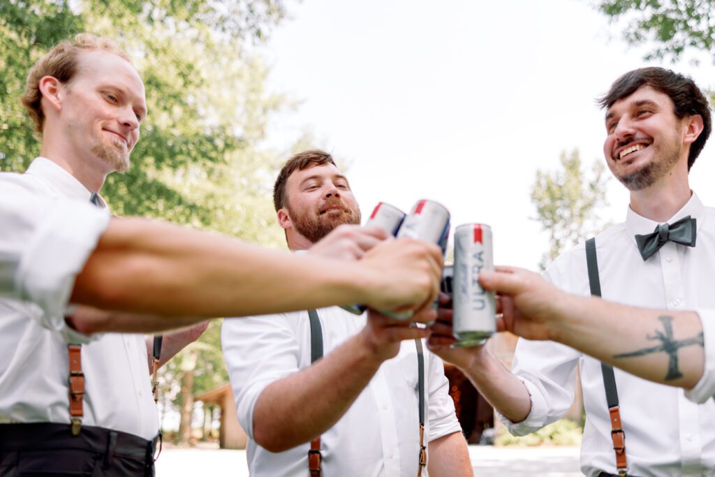 Group of groomsmen sharing laughs and relaxing together before an Alabama wedding ceremony.