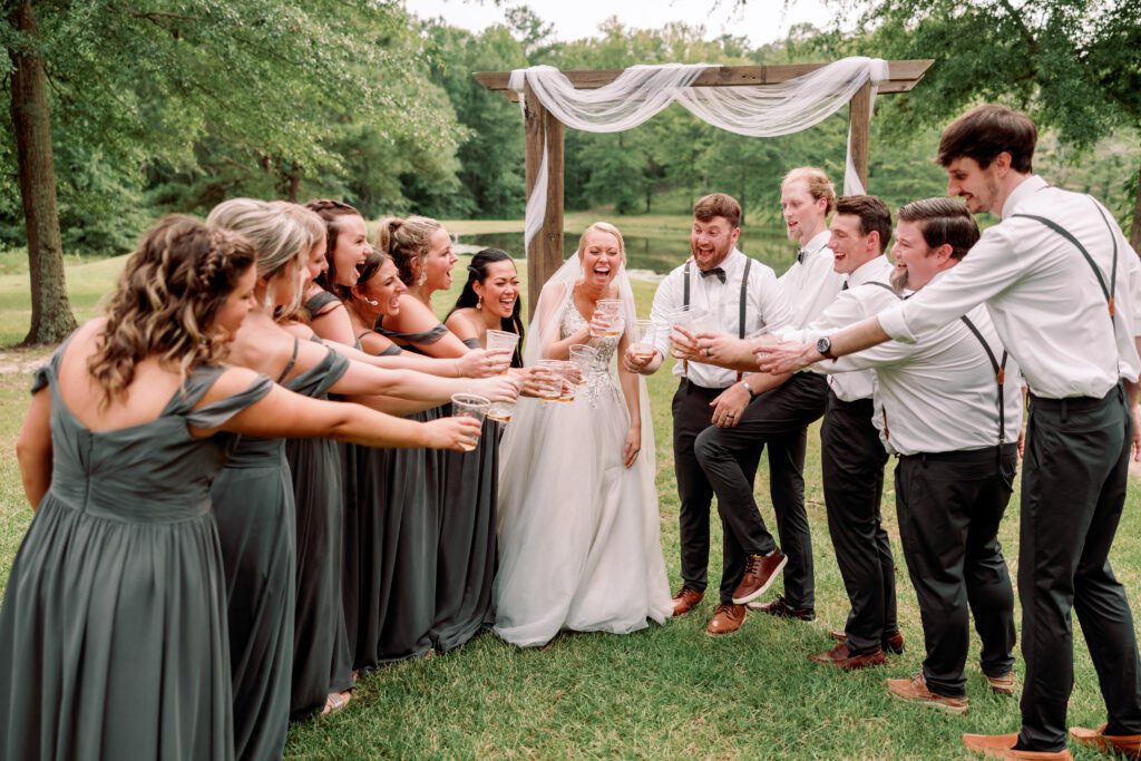 Documentary photography of candid wedding moment with entire bridal party at an Alabama wedding venue. 