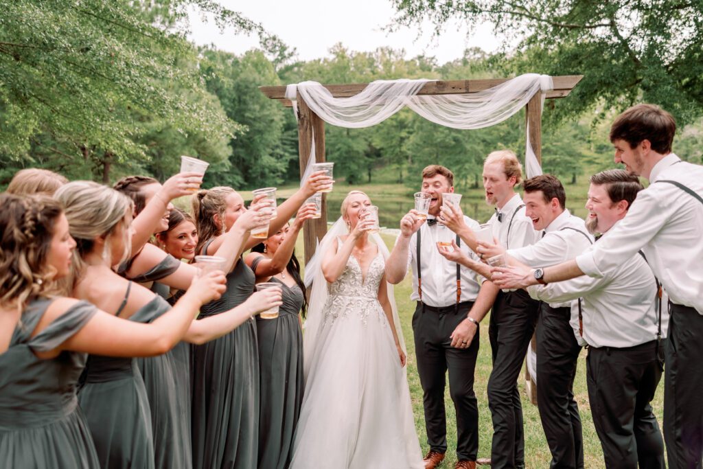 Documentary photography of candid wedding moment with entire bridal party at an Alabama wedding venue.