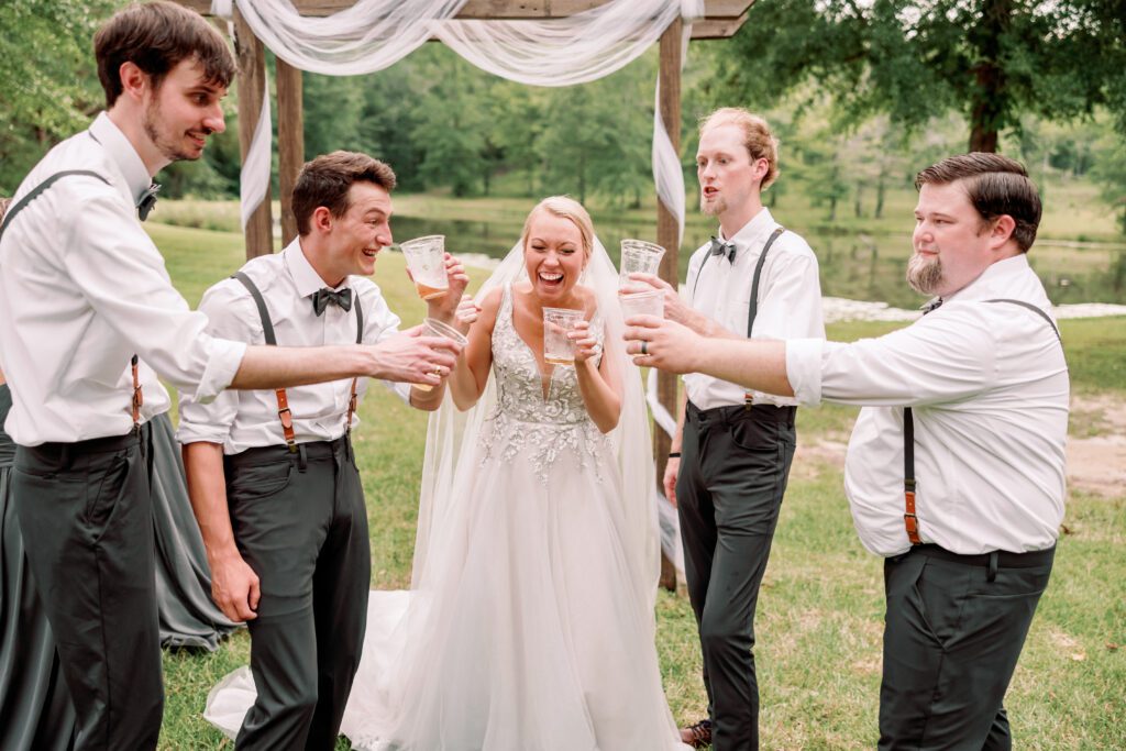 Documentary photography of candid wedding moment with entire bridal party at an Alabama wedding venue.
