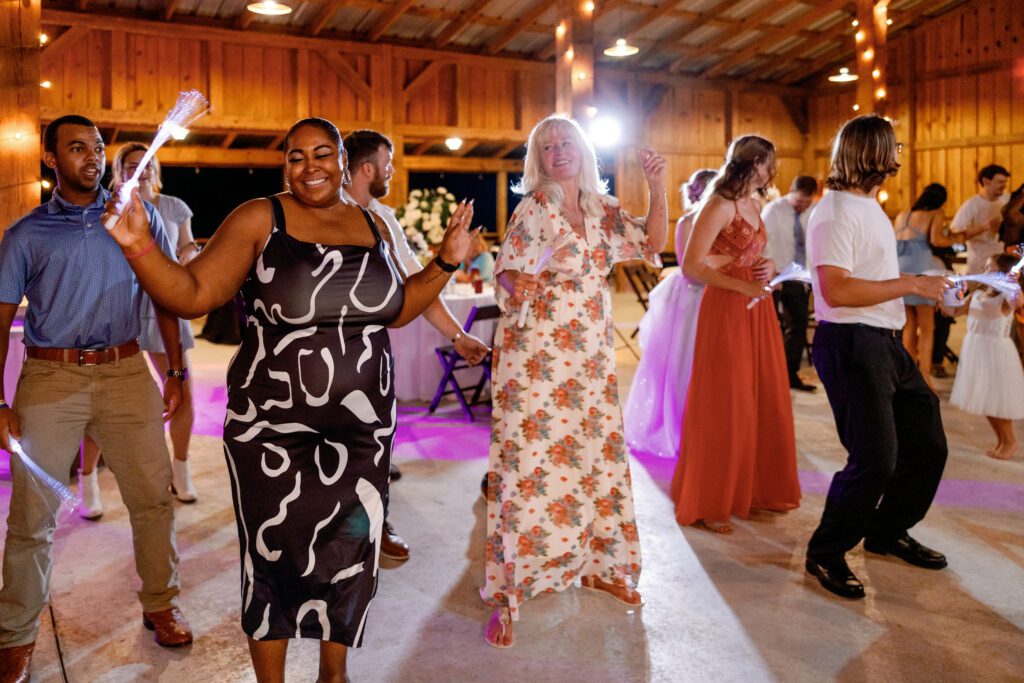 Documentary photography of fun wedding reception at an Alabama wedding venue.
